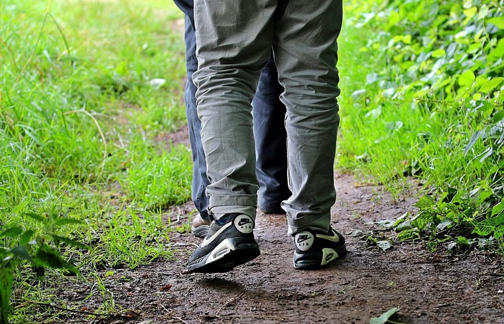 People walking on a forest trail as part of a daily step routine
