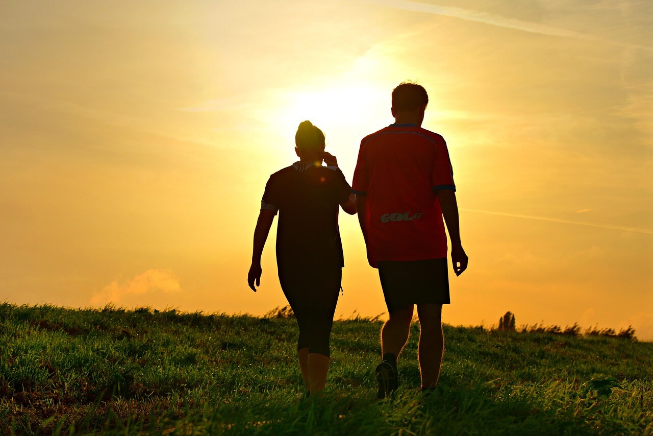A couple enjoying the amazing evening walk benefits during sunset