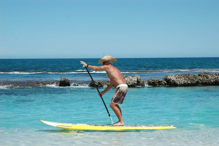 Person enjoying stand-up paddleboarding outdoors