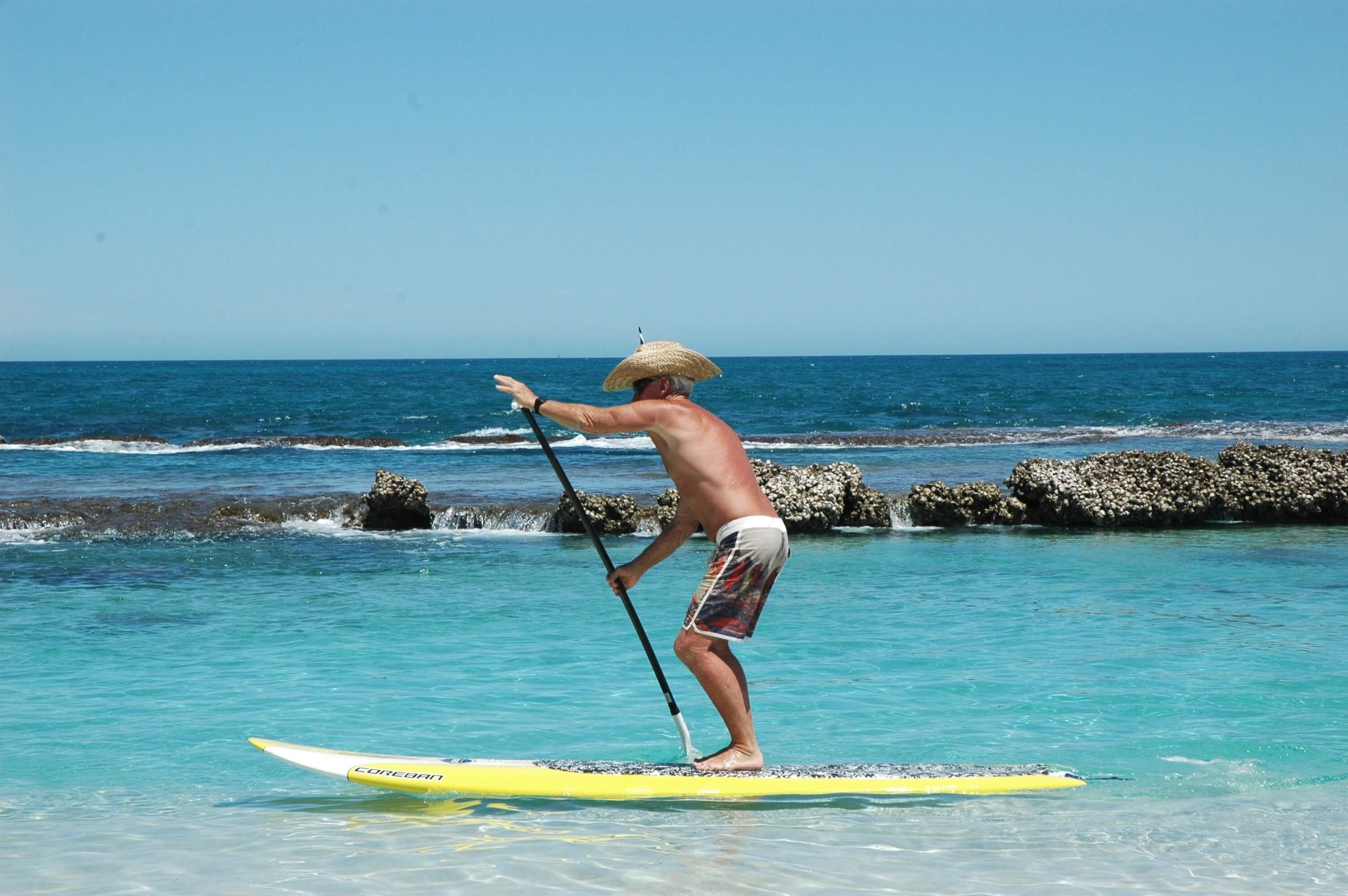 Person enjoying stand-up paddleboarding outdoors