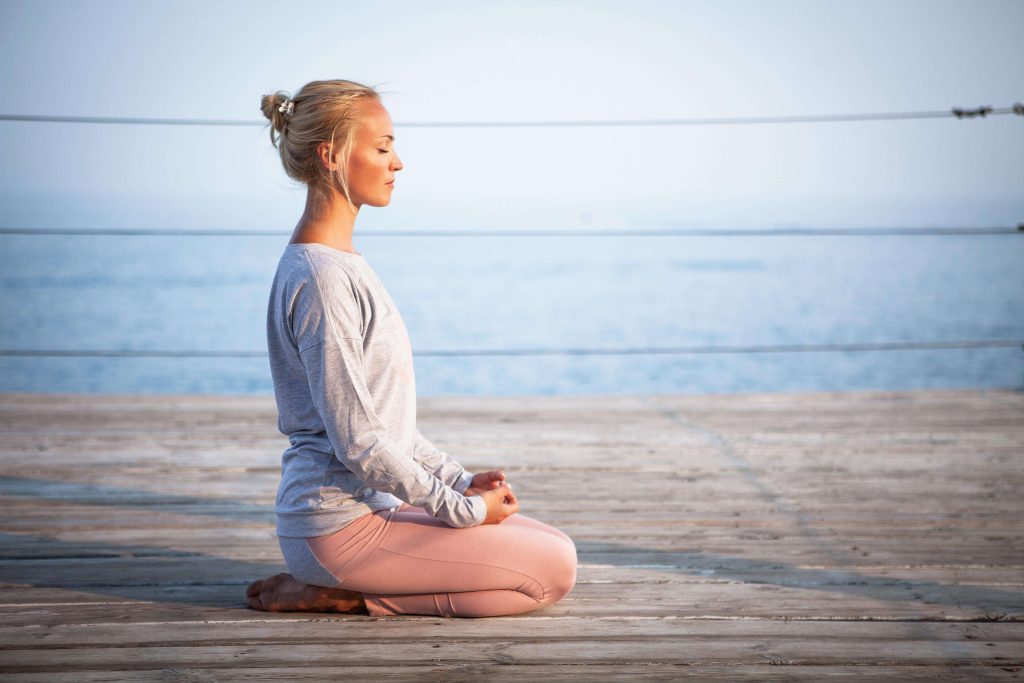 Woman meditating peacefully at home