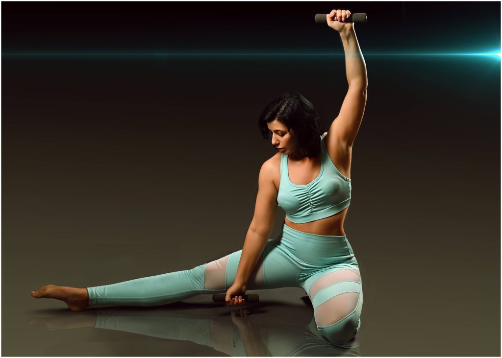 Young woman doing a gentle stretch after a workout